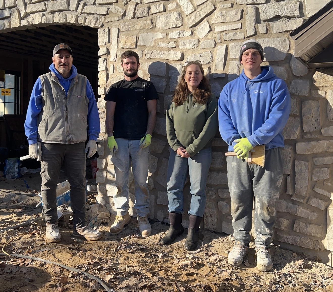The Paramount Masonry crew in front of a finished stone wall